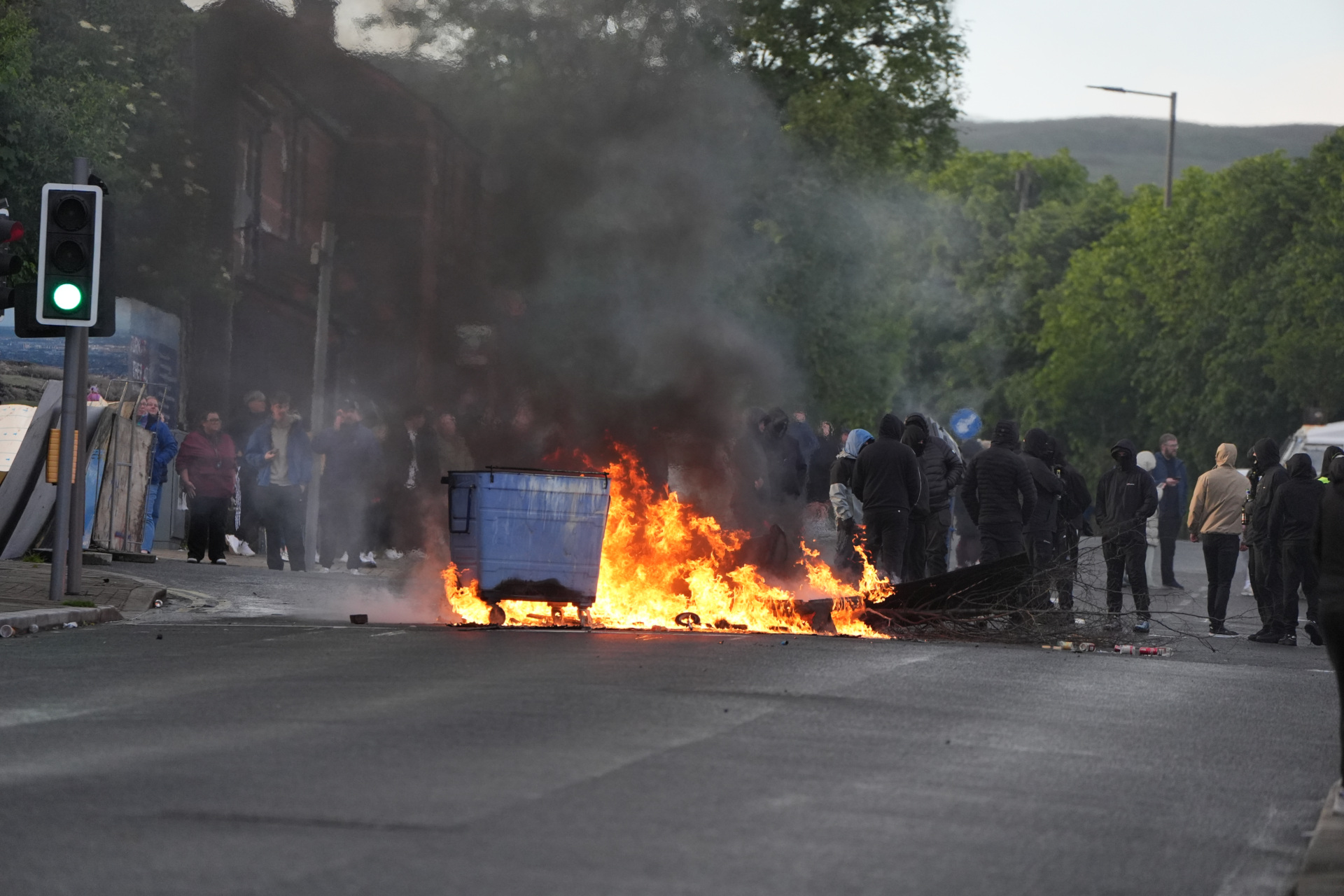 Bins set alight by protesters on Ligoniel Road, Belfast, as disorder flared during an anti-immigration demonstration organised in response to Monday night