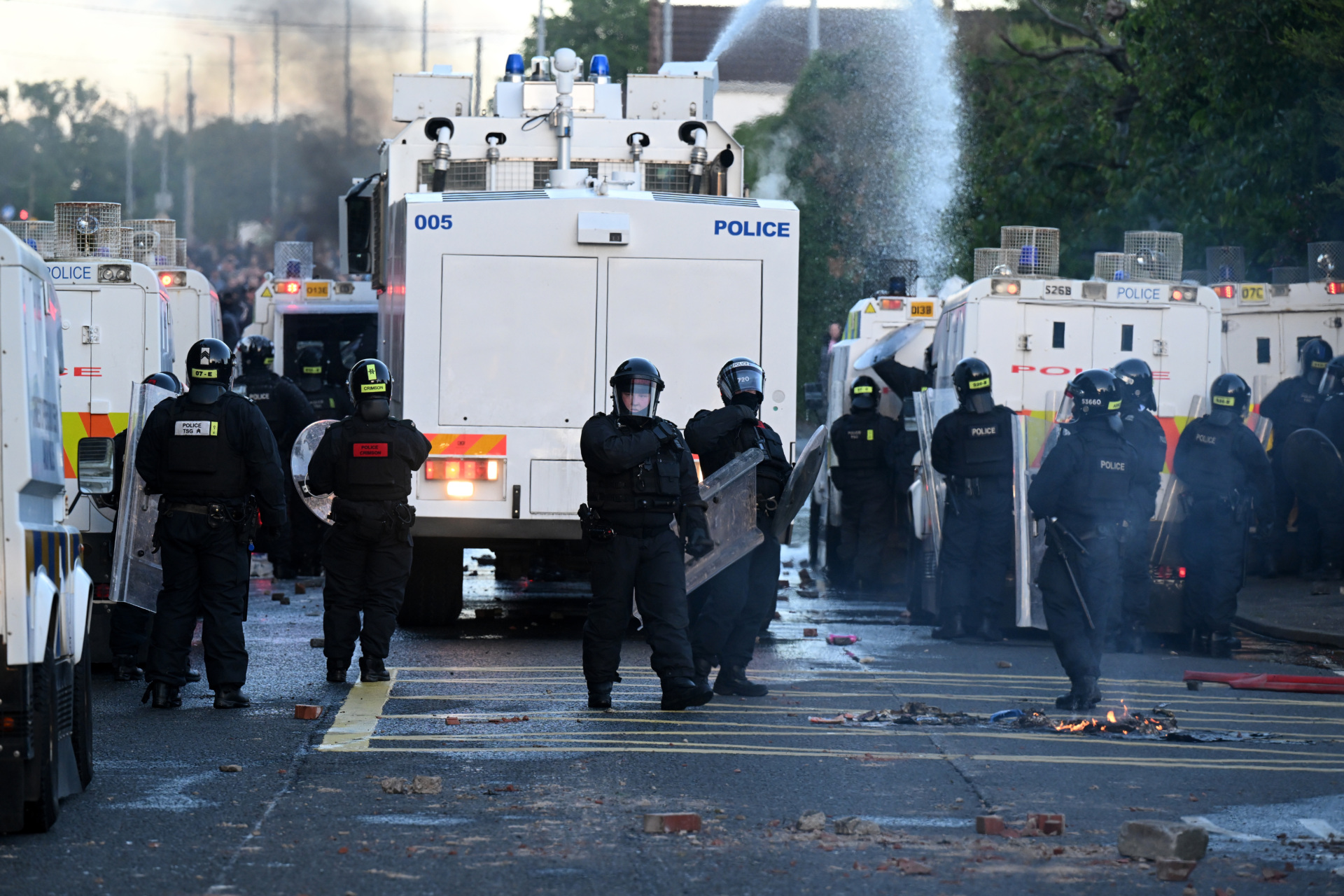 MALLUSK, NORTHERN IRELAND - JUNE 10: Police stand guard as protests take place near the Chimney Corner Hotel, which allegedly may be a hotel housing migrants, following a night of anti-immigrant riots on June 10, 2026 in Mallusk, Glengormley, Northern Ireland. Overnight protests in Belfast turned violent in reaction to a knife attack that took place on Monday night, which left a male victim in his 40